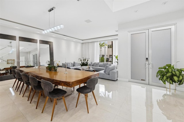 dining room featuring light tile floors, french doors, and an inviting chandelier