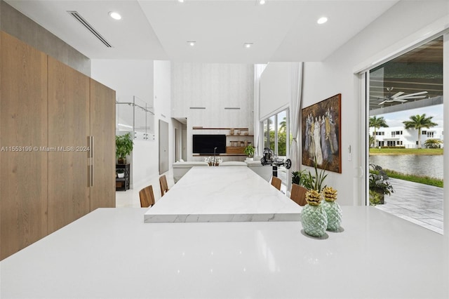 kitchen with a kitchen breakfast bar and a water view