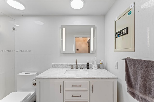 bathroom featuring vanity and toilet