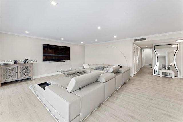 living room featuring crown molding and light wood-type flooring