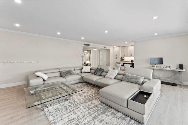 living room with light wood-type flooring and ornamental molding