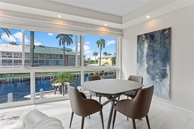 dining space featuring a water view