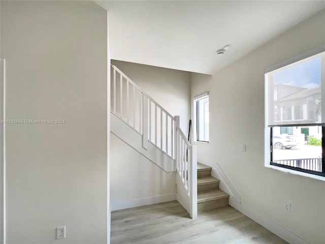 stairs with light wood-type flooring