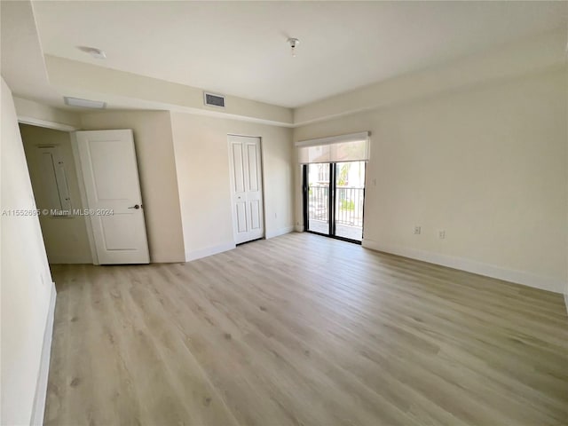 unfurnished bedroom featuring a closet and light hardwood / wood-style flooring