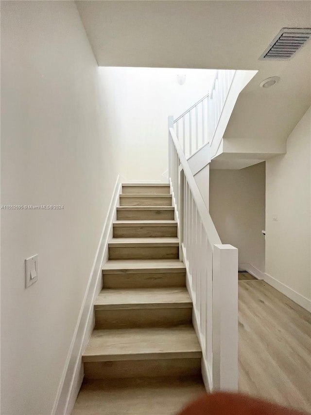 stairway featuring light hardwood / wood-style floors