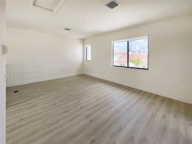 empty room with light hardwood / wood-style floors