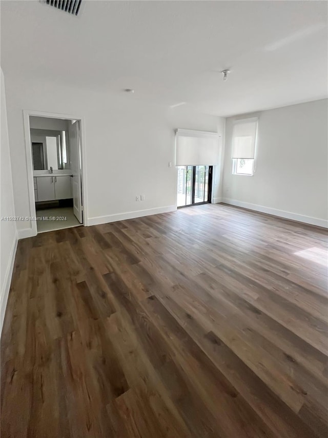 unfurnished living room featuring dark hardwood / wood-style flooring