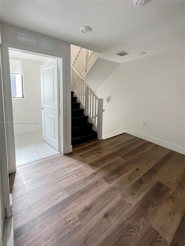 stairway featuring hardwood / wood-style floors