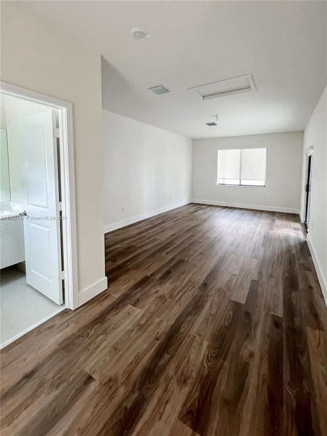 spare room with dark wood-type flooring