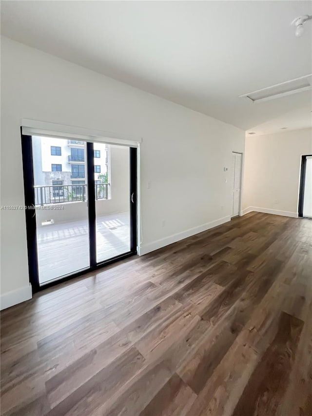 empty room with dark wood-type flooring