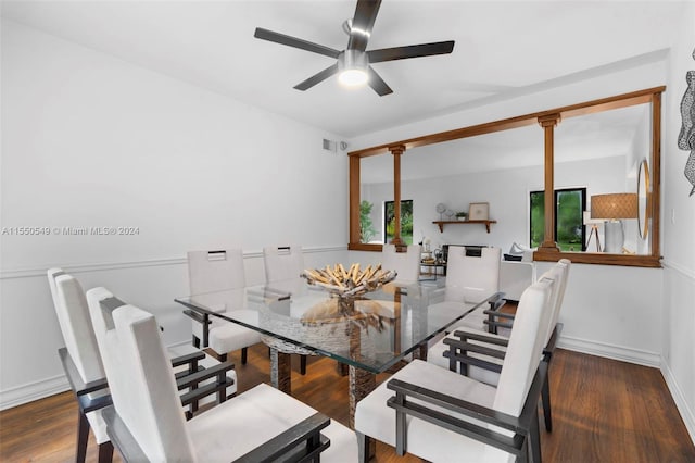 dining room featuring dark hardwood / wood-style flooring, ornate columns, and ceiling fan