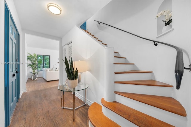 staircase with hardwood / wood-style flooring