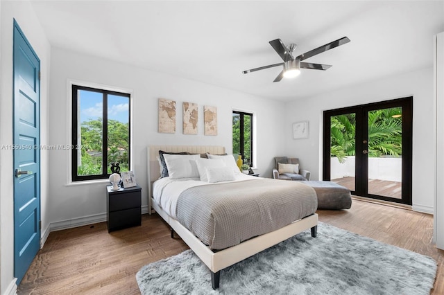 bedroom featuring hardwood / wood-style floors, ceiling fan, access to exterior, and french doors