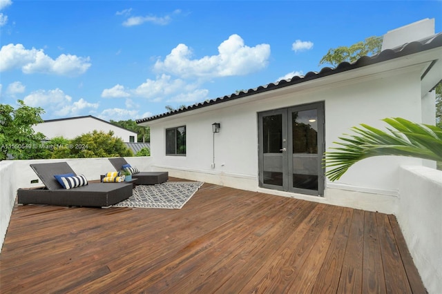 wooden deck with outdoor lounge area and french doors