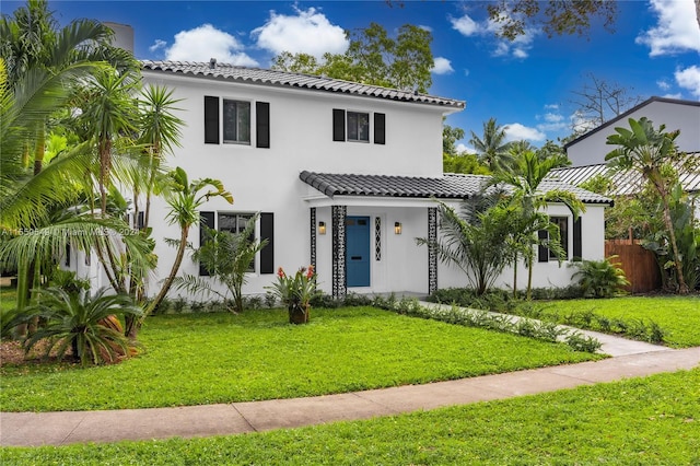 mediterranean / spanish home featuring a front yard