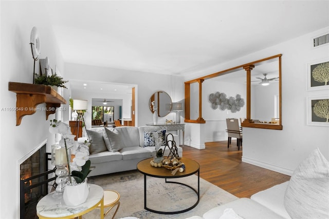 living room featuring hardwood / wood-style floors and ceiling fan