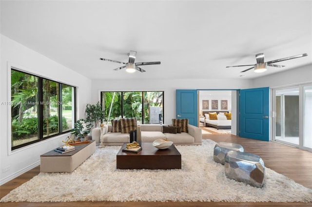 living room with hardwood / wood-style floors and ceiling fan