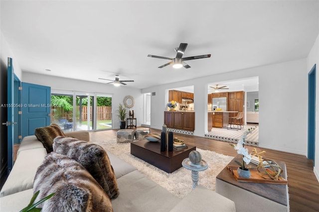 living room with hardwood / wood-style floors and ceiling fan