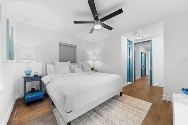 bedroom with dark wood-type flooring and ceiling fan