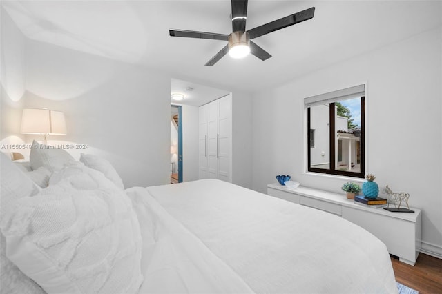 bedroom featuring hardwood / wood-style flooring, ceiling fan, and a closet