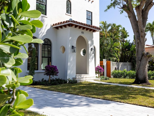 mediterranean / spanish home featuring a front yard