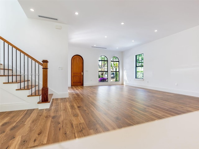 unfurnished living room featuring hardwood / wood-style flooring