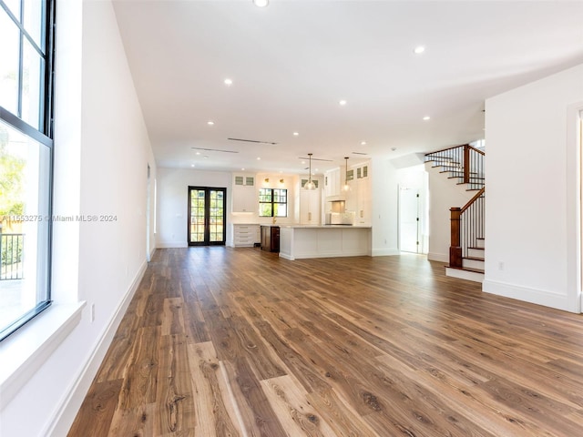 unfurnished living room with french doors and dark hardwood / wood-style floors