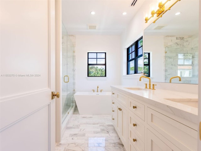 bathroom with vanity and shower with separate bathtub