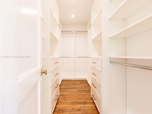 spacious closet with light hardwood / wood-style flooring