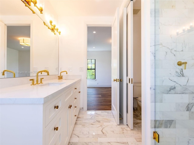 bathroom featuring tiled shower, wood-type flooring, vanity, and toilet