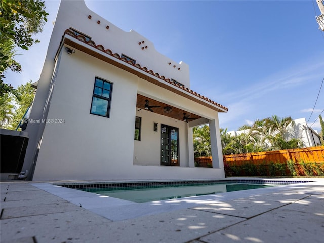 view of swimming pool featuring ceiling fan and a patio