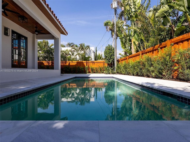 view of pool with a patio area, ceiling fan, and french doors