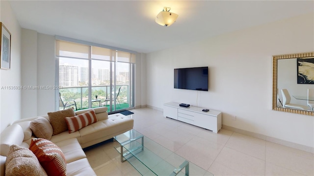 living room featuring light tile flooring and a wall of windows