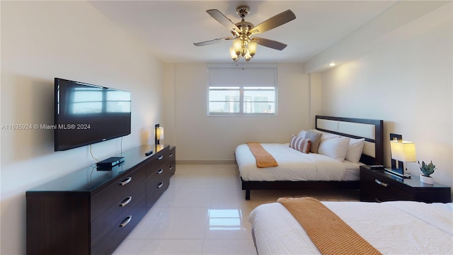 tiled bedroom with ceiling fan