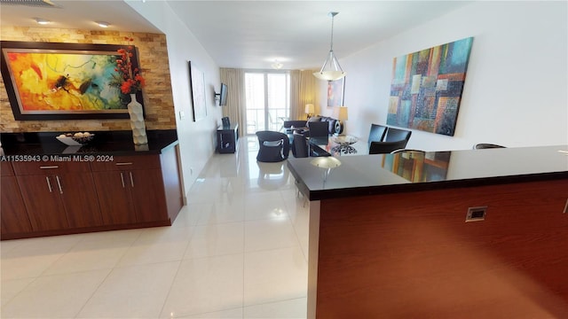 interior space featuring decorative light fixtures and light tile flooring