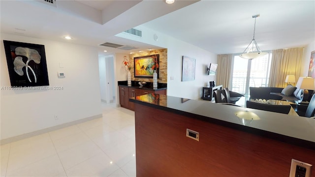 kitchen featuring decorative light fixtures and light tile floors