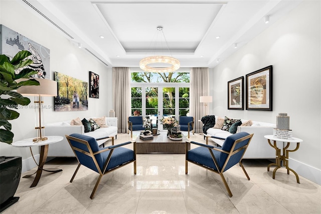 sitting room with french doors and a raised ceiling