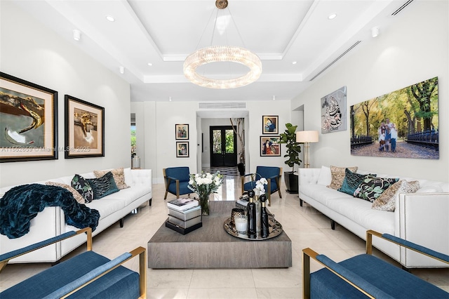 living room with a notable chandelier, light tile patterned floors, and a tray ceiling