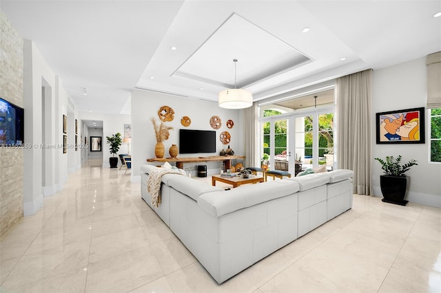 living room with a raised ceiling and french doors