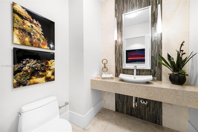 bathroom with sink, tile patterned flooring, and toilet