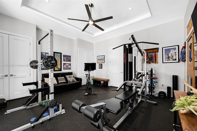 interior space featuring ceiling fan and a raised ceiling