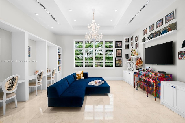 living room featuring an inviting chandelier and a tray ceiling