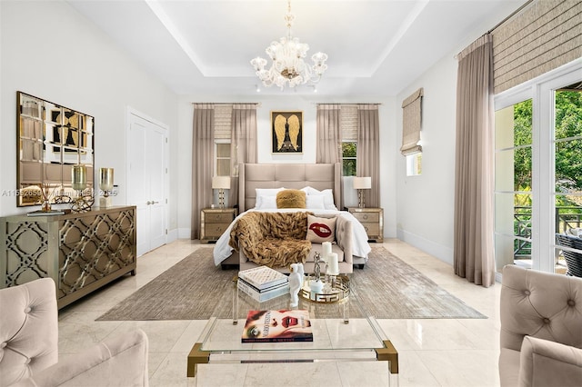 tiled bedroom featuring a notable chandelier, a raised ceiling, and multiple windows