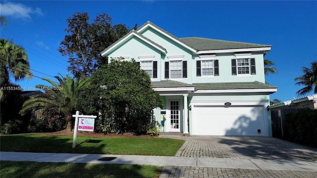 view of front of home featuring a front yard and a garage