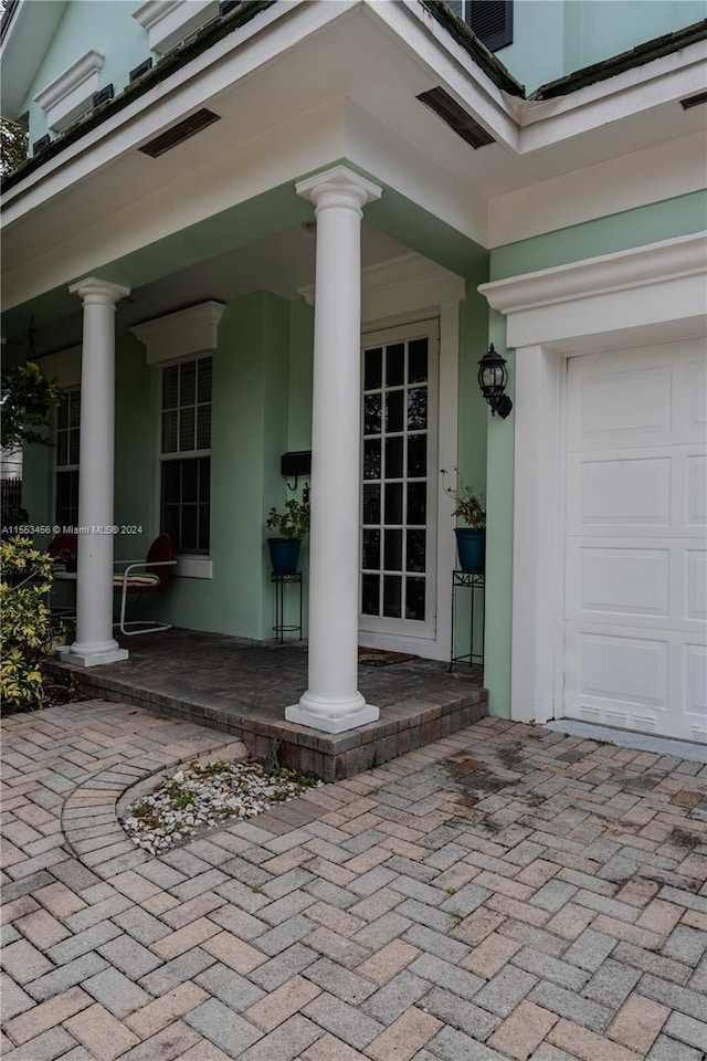 view of exterior entry with a porch