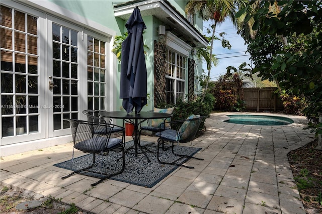 view of patio featuring a fenced in pool and french doors