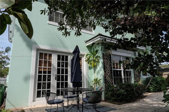 view of side of property with french doors and a patio