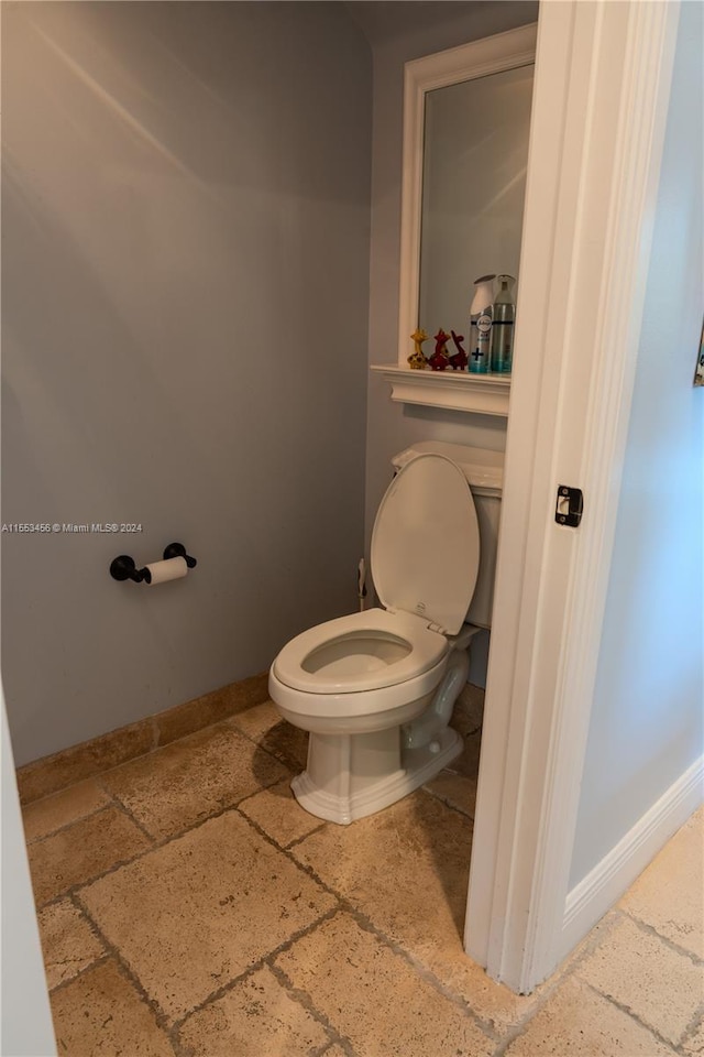 bathroom with toilet and tile flooring