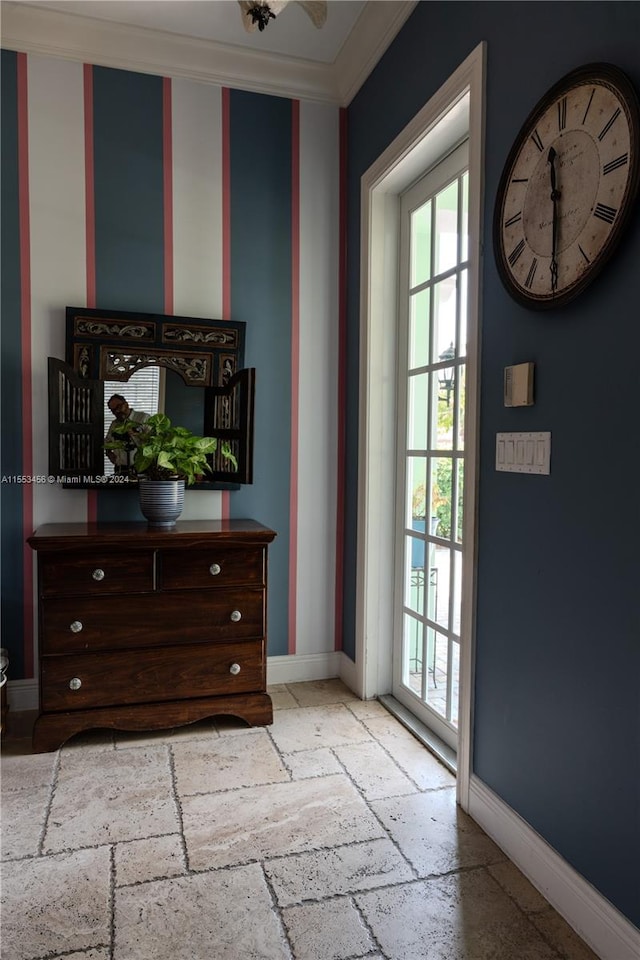 entryway with plenty of natural light and ornamental molding