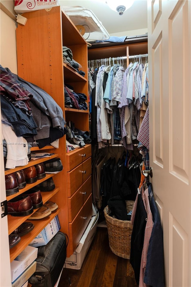 walk in closet featuring dark wood-type flooring